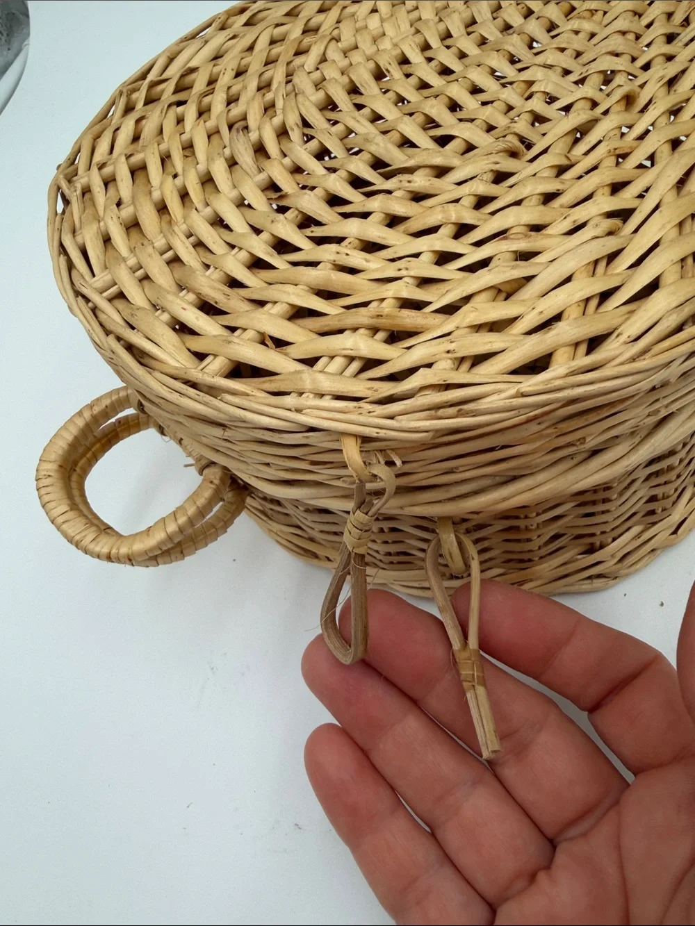 A Cute, charming vintage shell-shaped rattan storage basket with a front handle.